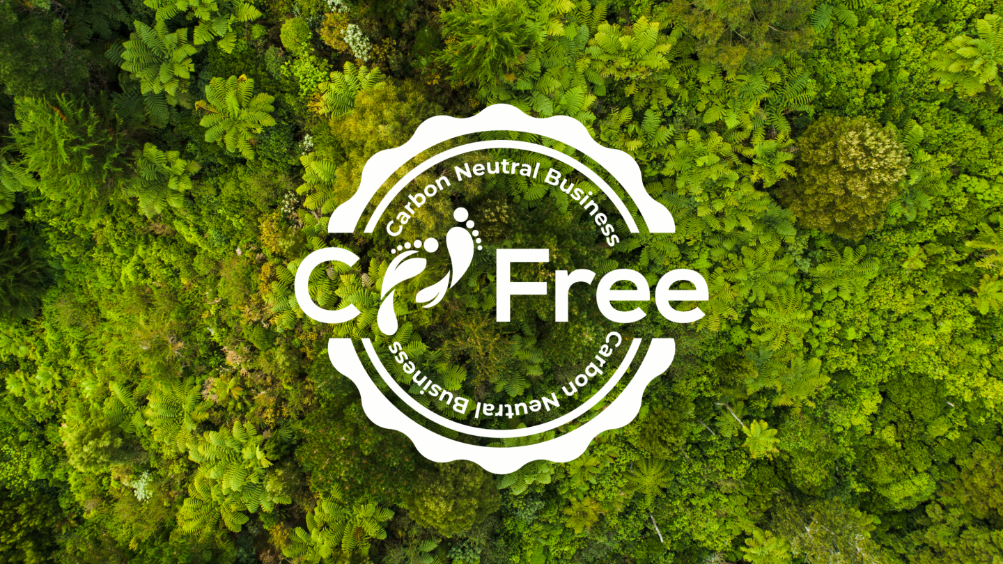 White CFree logo over a background of green trees