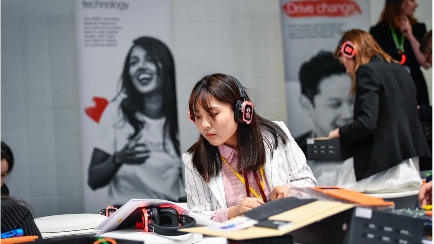 girl with headphones on at an event engaged in an activity